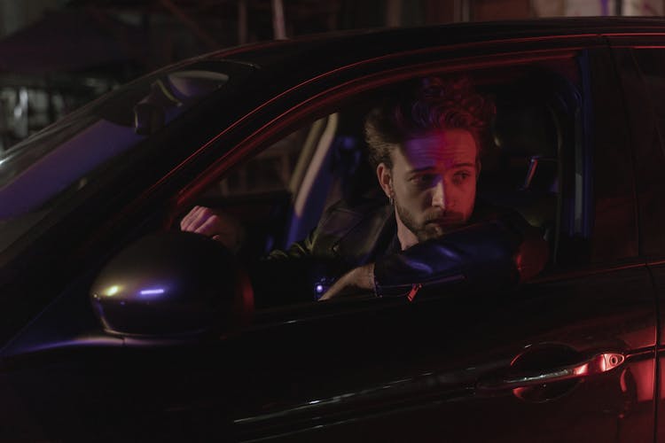 Man In Black Leather Jacket Driving Car