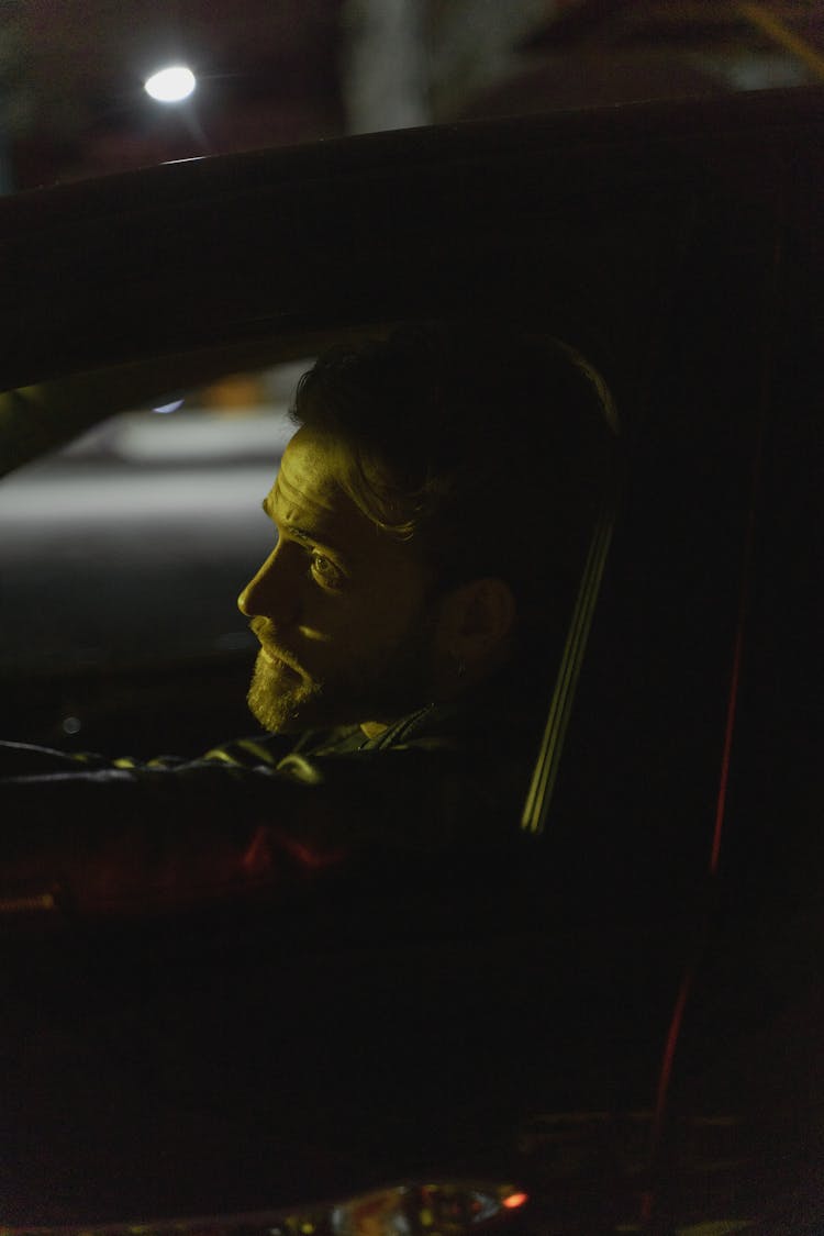 Man In Red Jacket Driving Car