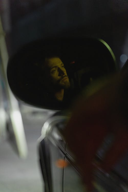 Reflection of a Man From the Side Mirror