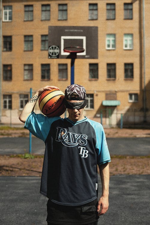 Man in Blue Crew Neck T-shirt Holding Basketball