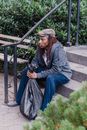Woman in Gray Coat Sitting on Gray Concrete Stairs