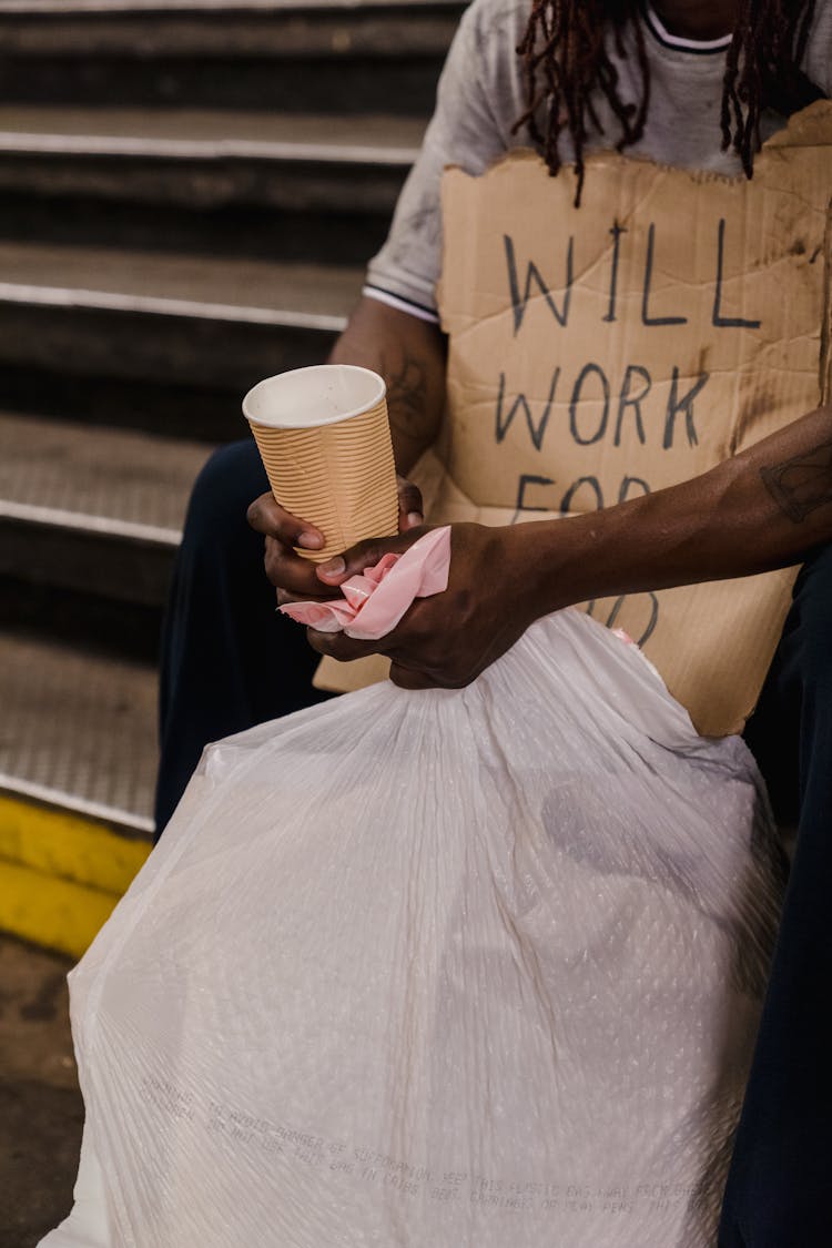 Man With Placard Begging On Street