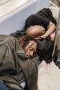 Two Homeless Men Sleeping on the Bench
