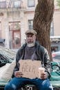 A Man Sitting on a Bench Asking for Help