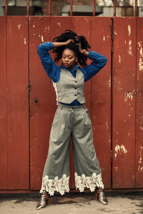 Woman Wearing Blue Dress Shirt, Gray Waistcoat, and Pants