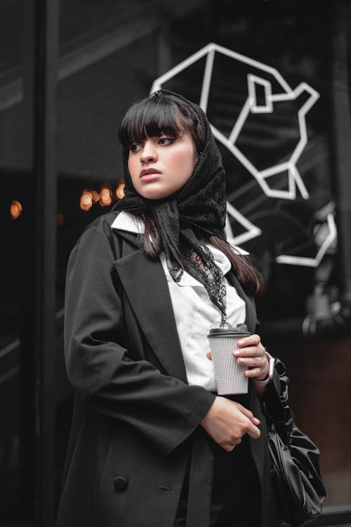 Free Woman in Black Coat Holding White and Black Ceramic Mug Stock Photo