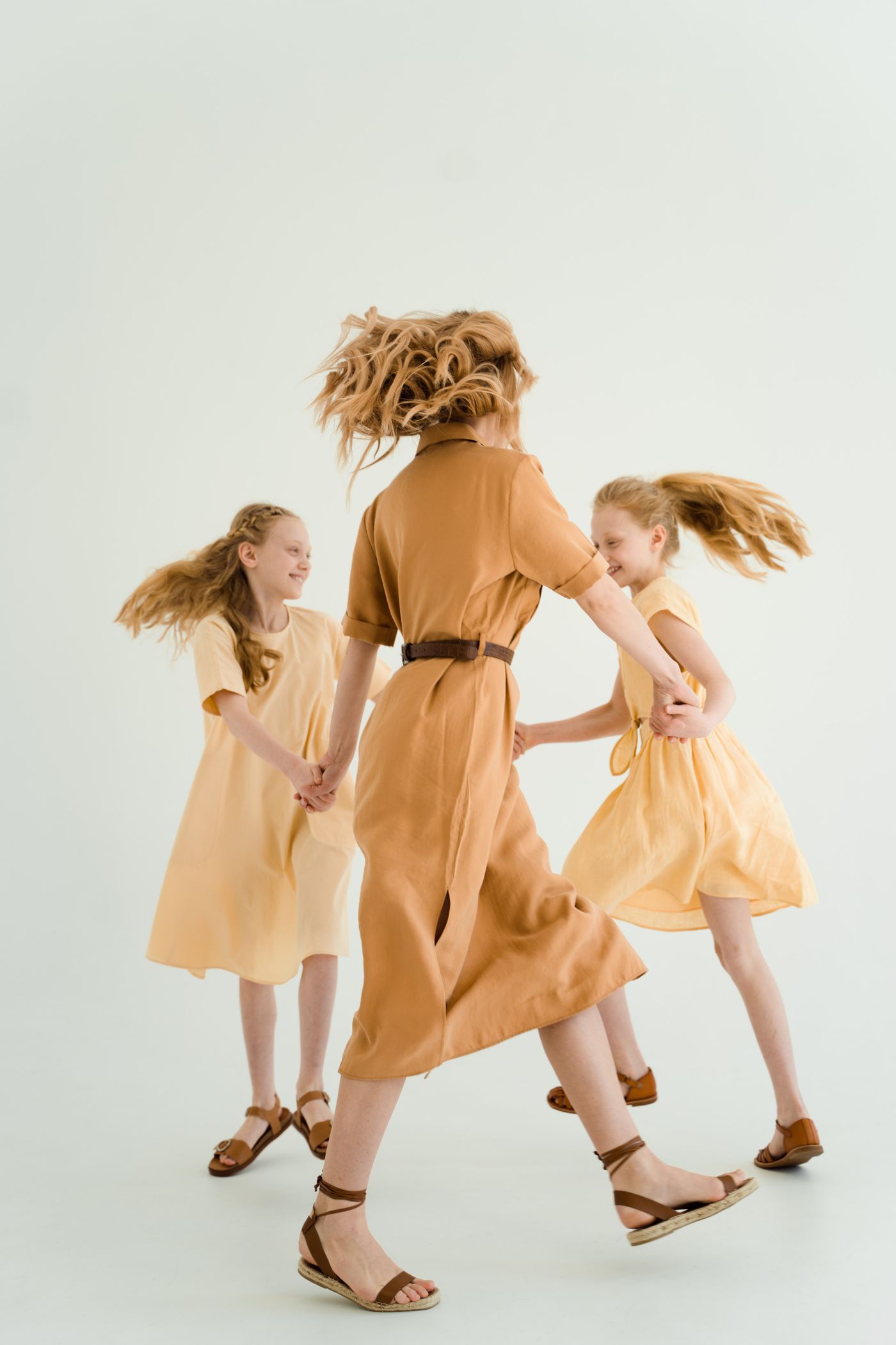 A mother and children dancing together; illustrative stock photograph
