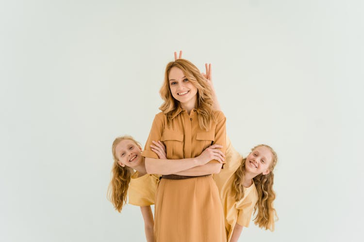 Girls Standing Behind A Woman