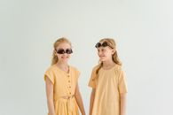 Woman in Brown Button Up Shirt Wearing Black Sunglasses