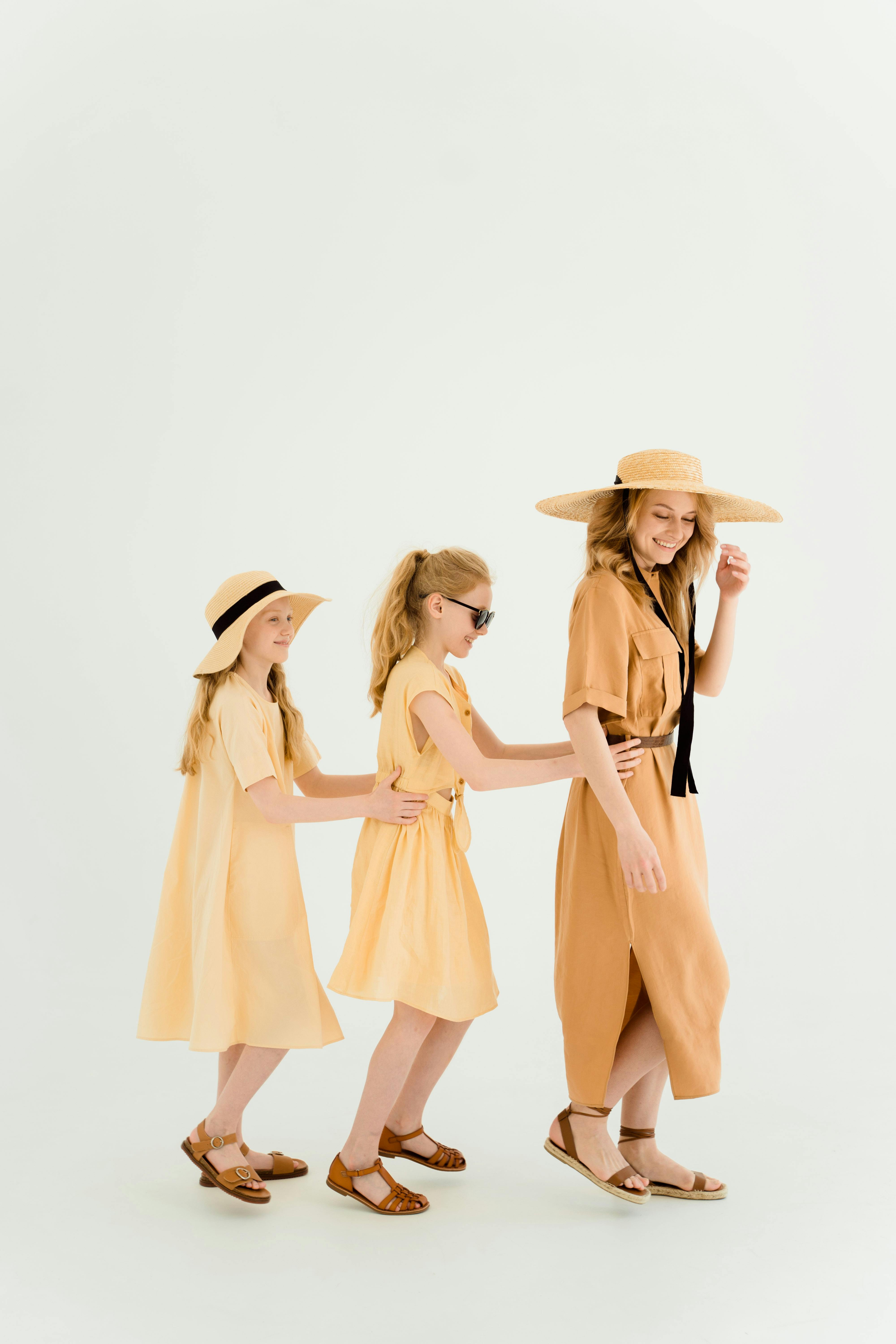 a woman and two girls playing together