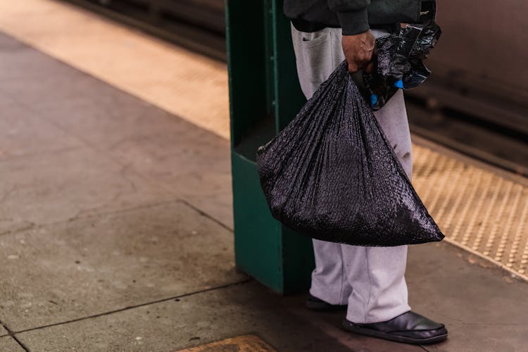 Man Holding Bag At Subway Station