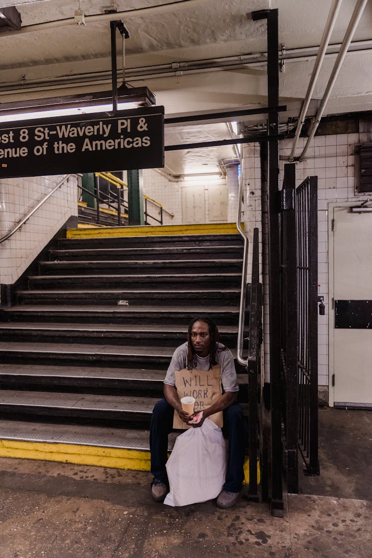 Homeless Man Sitting On Stairs 