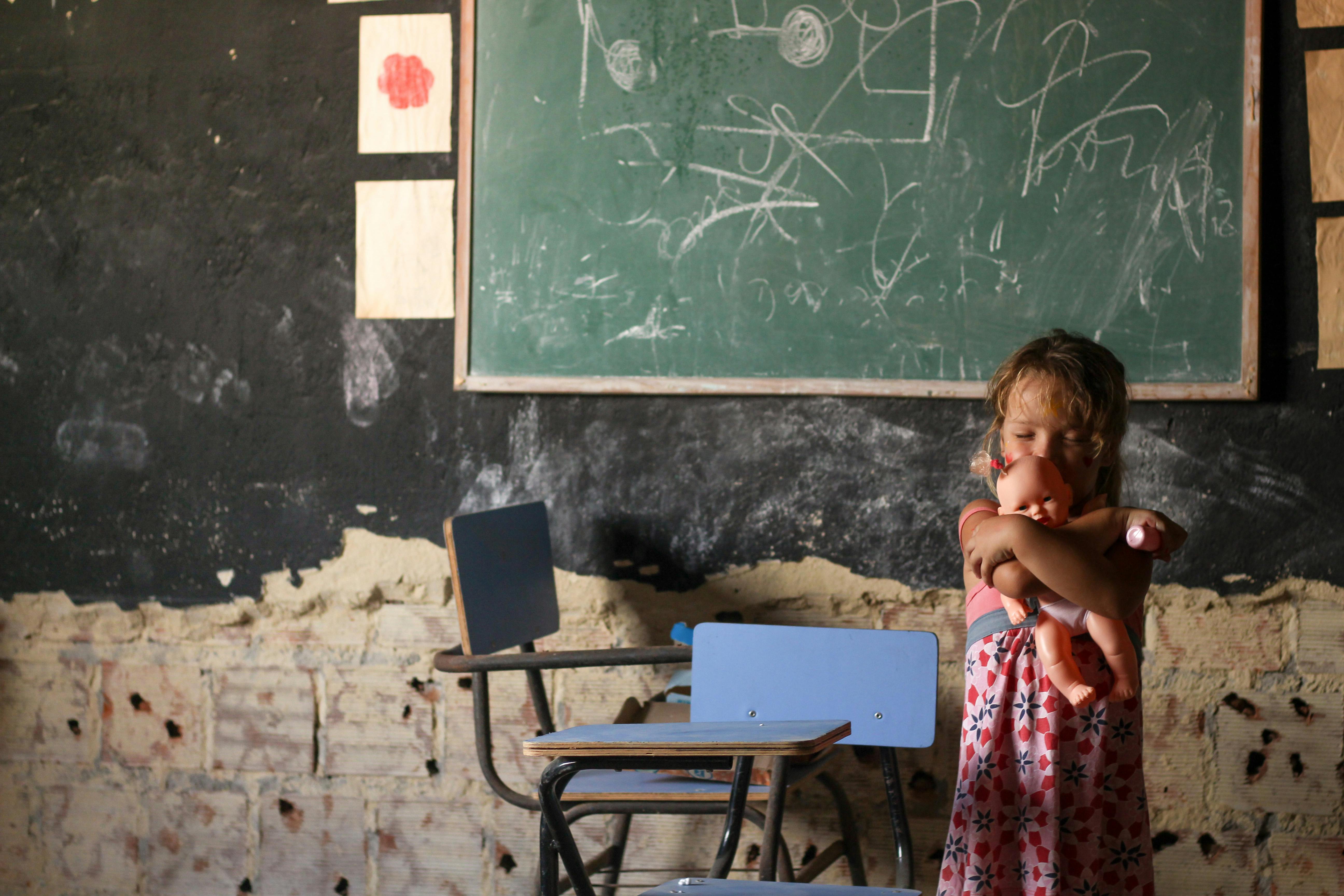 a girl playing a baby doll