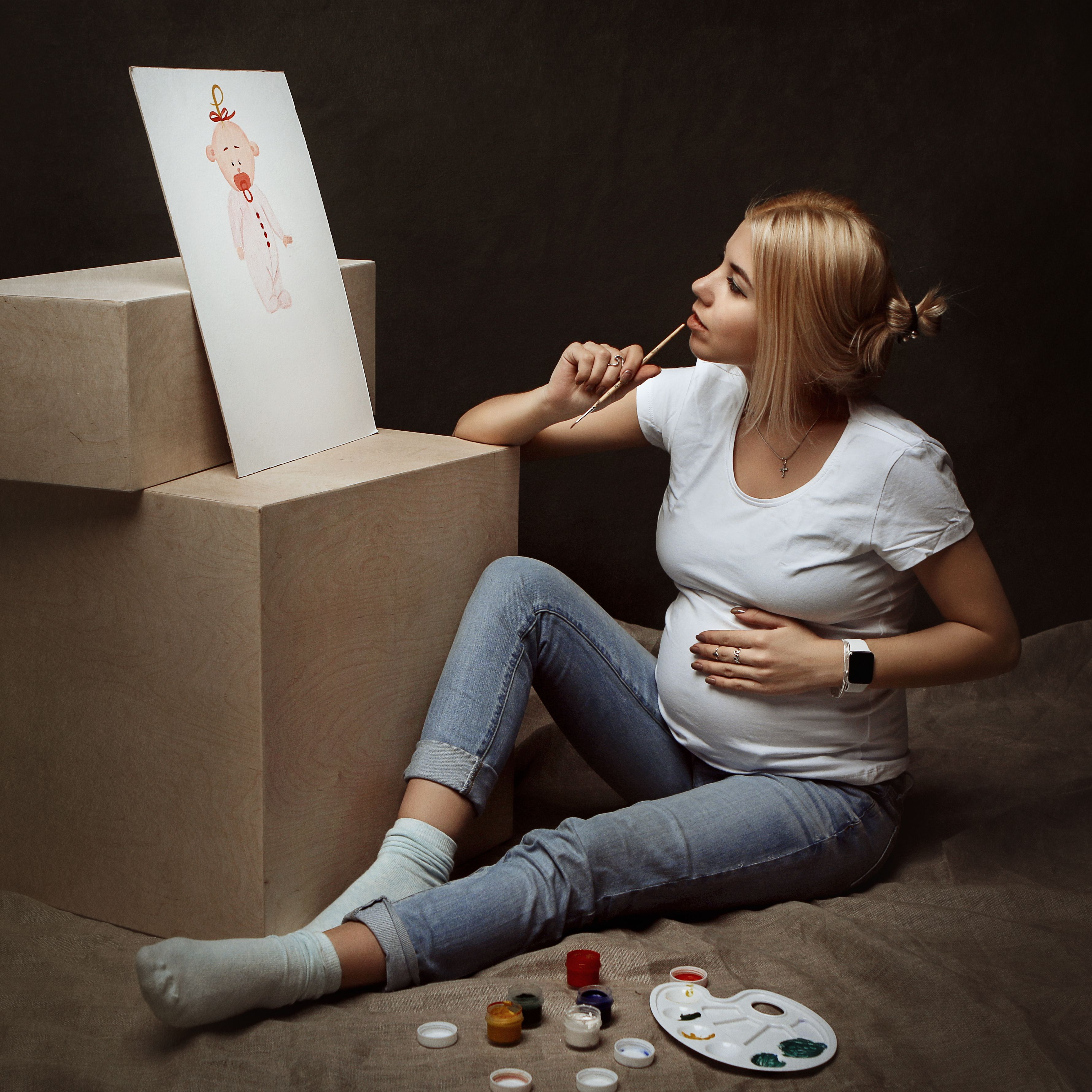 A Pregnant Woman Painting a Picture