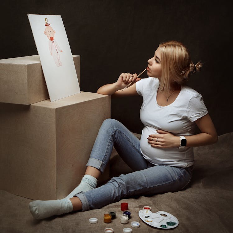 A Pregnant Woman Painting A Picture