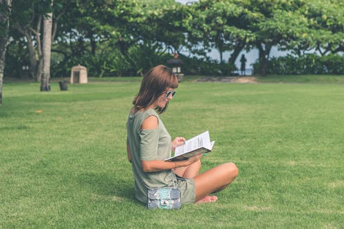 Free Woman Wearing Green Top Reading Book Stock Photo