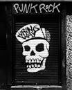 Funky skull graffiti on locked roll down black door