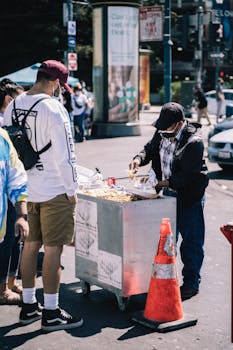 A bustling street vendor serves hot dogs in San Francisco, showcasing urban street food culture.