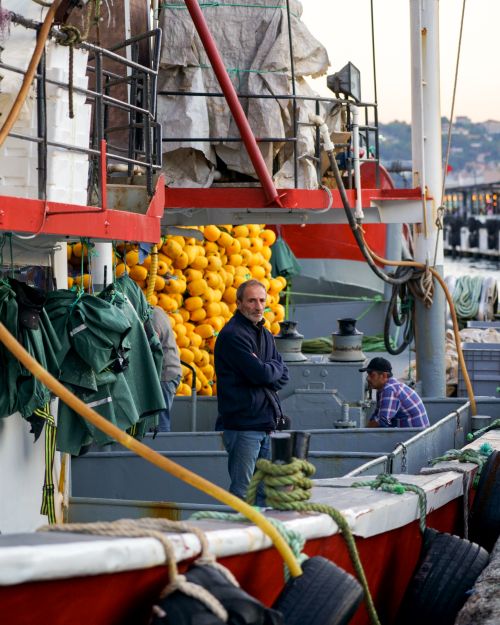 Free Fishermen on a docked boat in İstanbul, surrounded by nets and equipment. Stock Photo