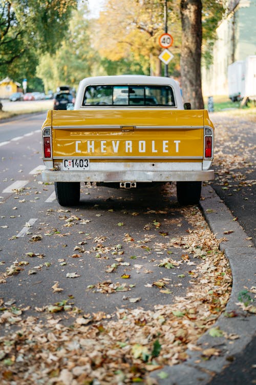 Yellow Chevrolet Crew Cab Pickup Truck on Road