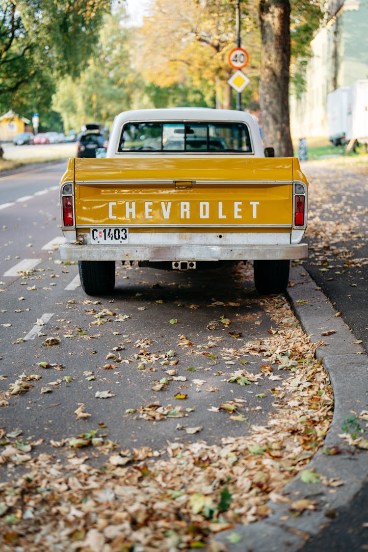 Yellow Chevrolet Crew Cab Pickup Truck On Road