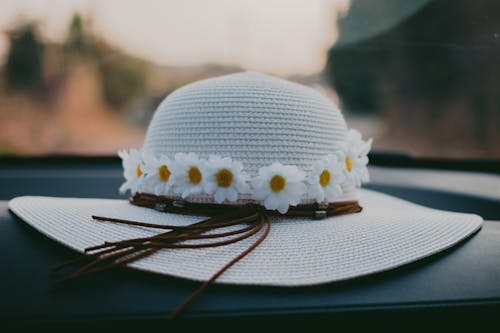Close-Up Shot of White Sun Hat Designed with White Flowers