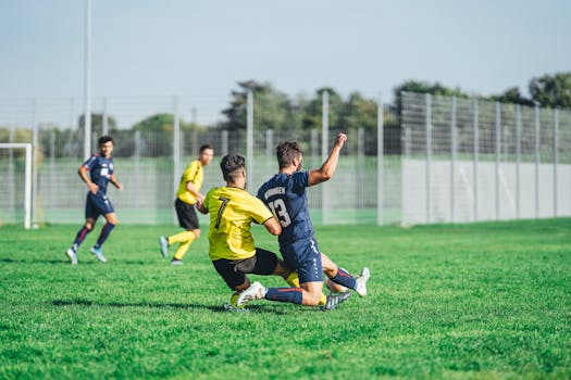 Soccer players in action during a competitive match on a sunny day outdoors.