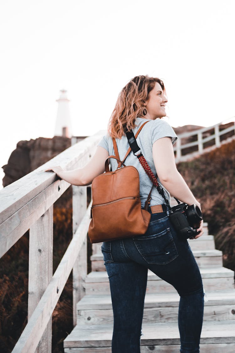 Back View Of A Woman Climbing Wooden Stairs