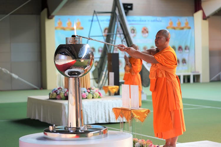 Monk Lighting Fire In Ceremony