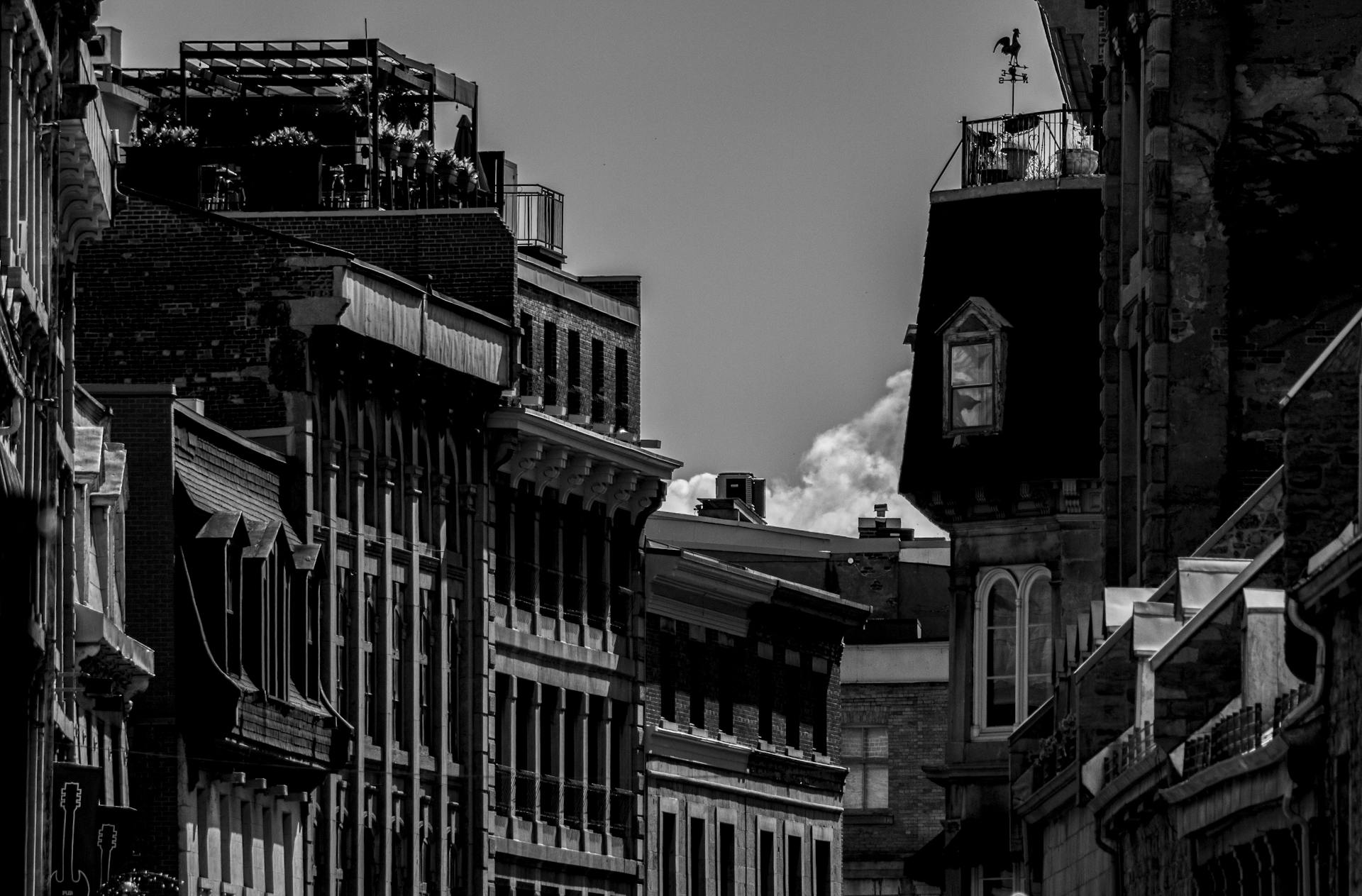 Black and white capture of historic buildings in Montreal with classic architectural details.