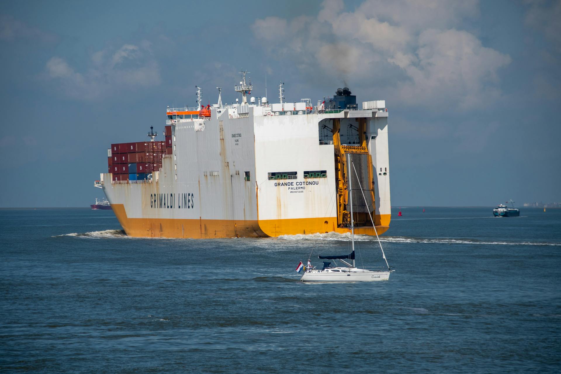 Grimaldi Lines cargo ship sailing in Terneuzen, Netherlands on a clear day.
