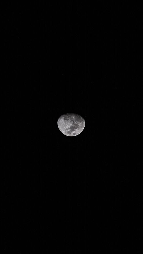 Free A stunning close-up of the moon against a dark night sky, highlighting its craters and texture. Stock Photo