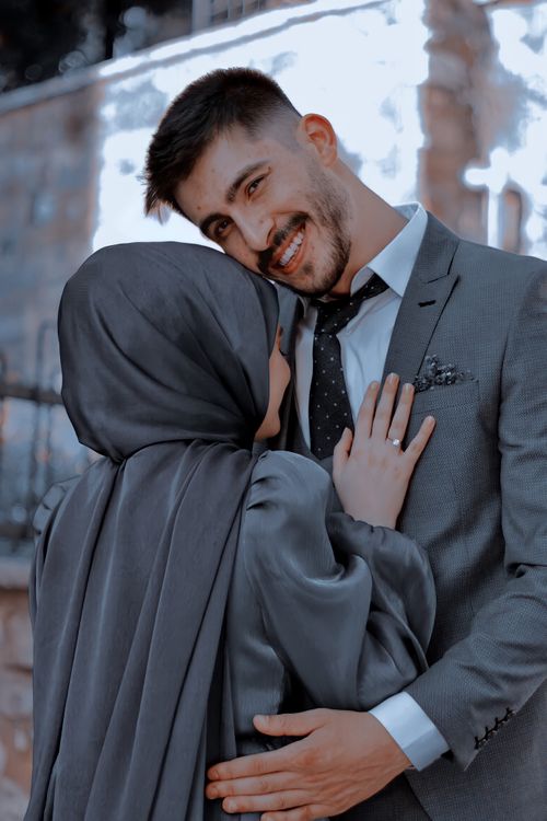 Free A joyful couple in formal attire embraces, showcasing love and elegance. Stock Photo