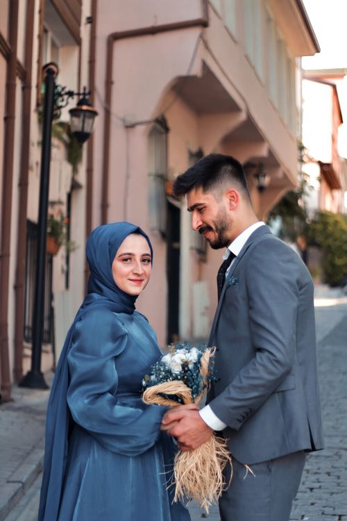 Free Happy bride and groom enjoying their wedding day on a picturesque street. Stock Photo