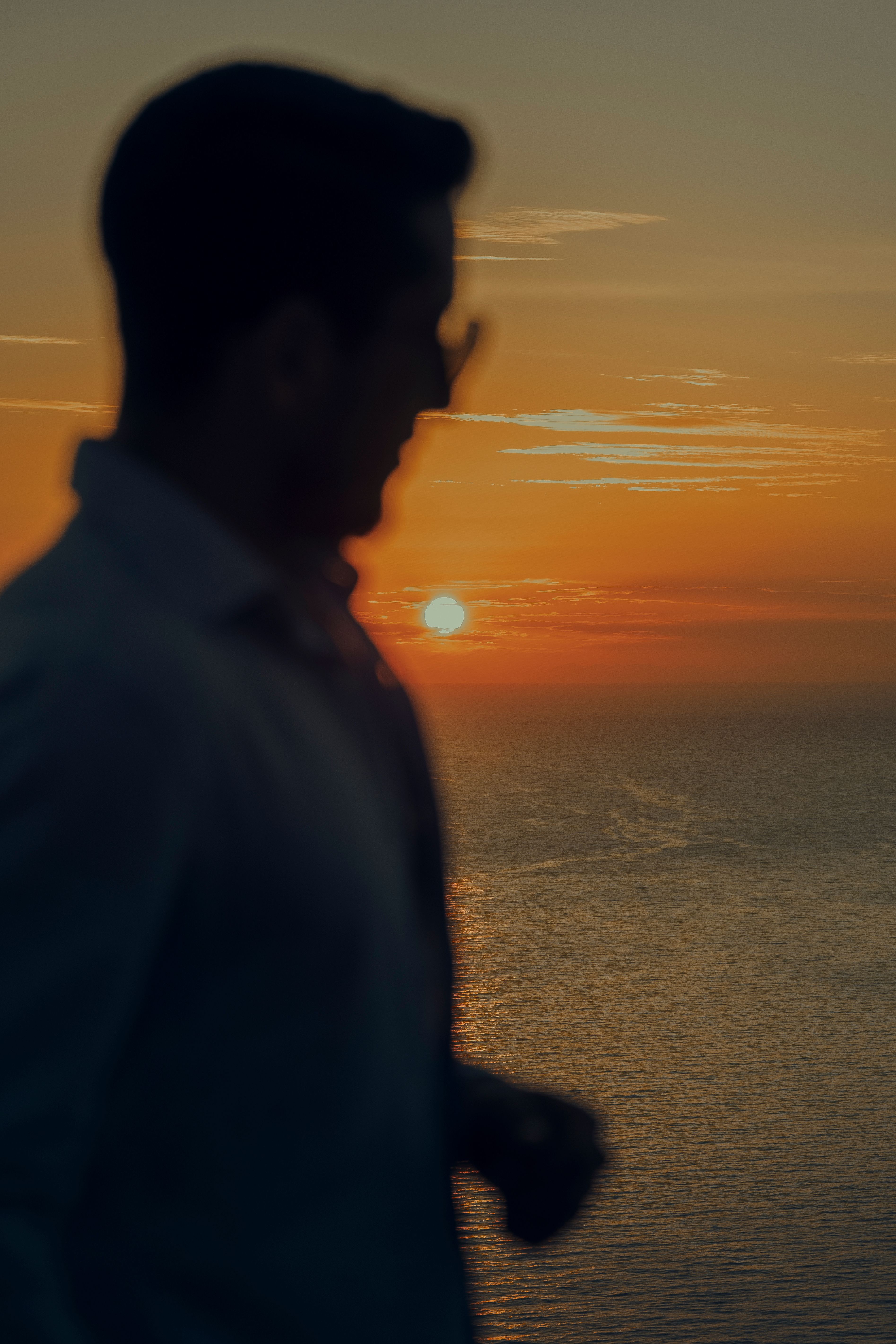 Silhouette of Man Standing Near the Sea during Sunset · Free Stock Photo