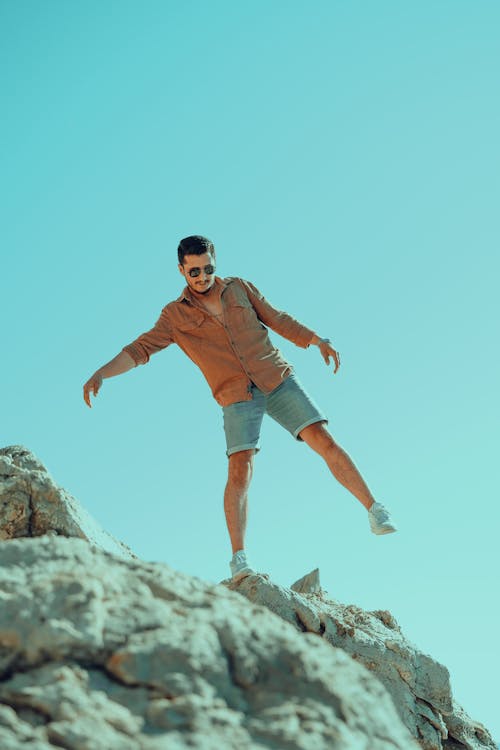 A Man Balancing on the Rock Formation