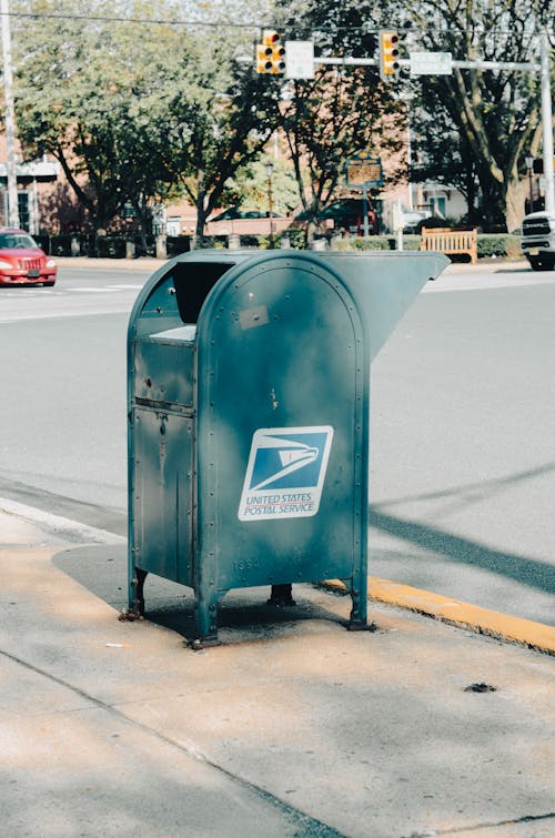 A Blue Metal Mail Box on the Side of the Road