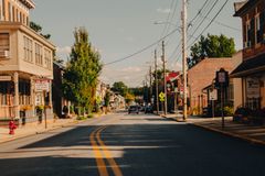Picturesque view of a quiet street in Manheim, PA with historic buildings and clear sky.