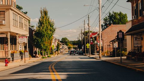 Picturesque view of a quiet street in Manheim, PA with historic buildings and clear sky.