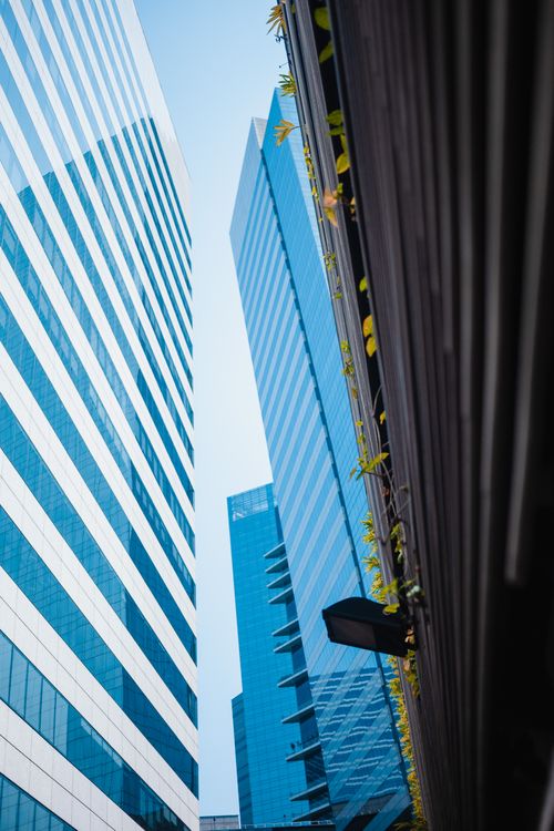 Free Low-angle view of sleek skyscrapers capturing urban architecture in daylight. Stock Photo