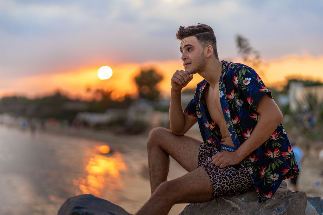 A Man Sitting on the Rock Formation · Free Stock Photo