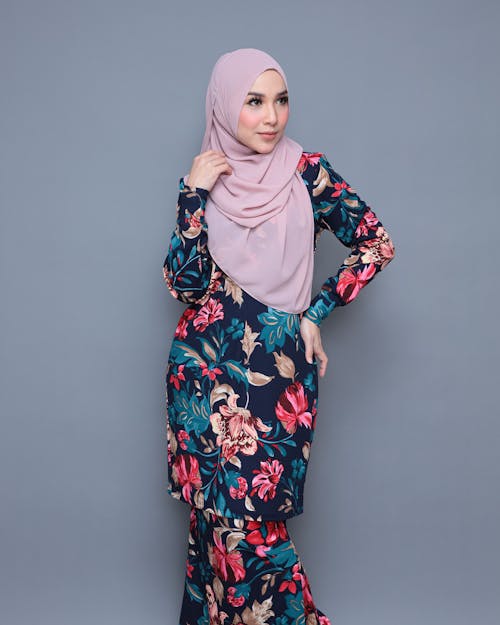 Woman in Floral Long Dress Wearing Pink Hijab while Looking Afar