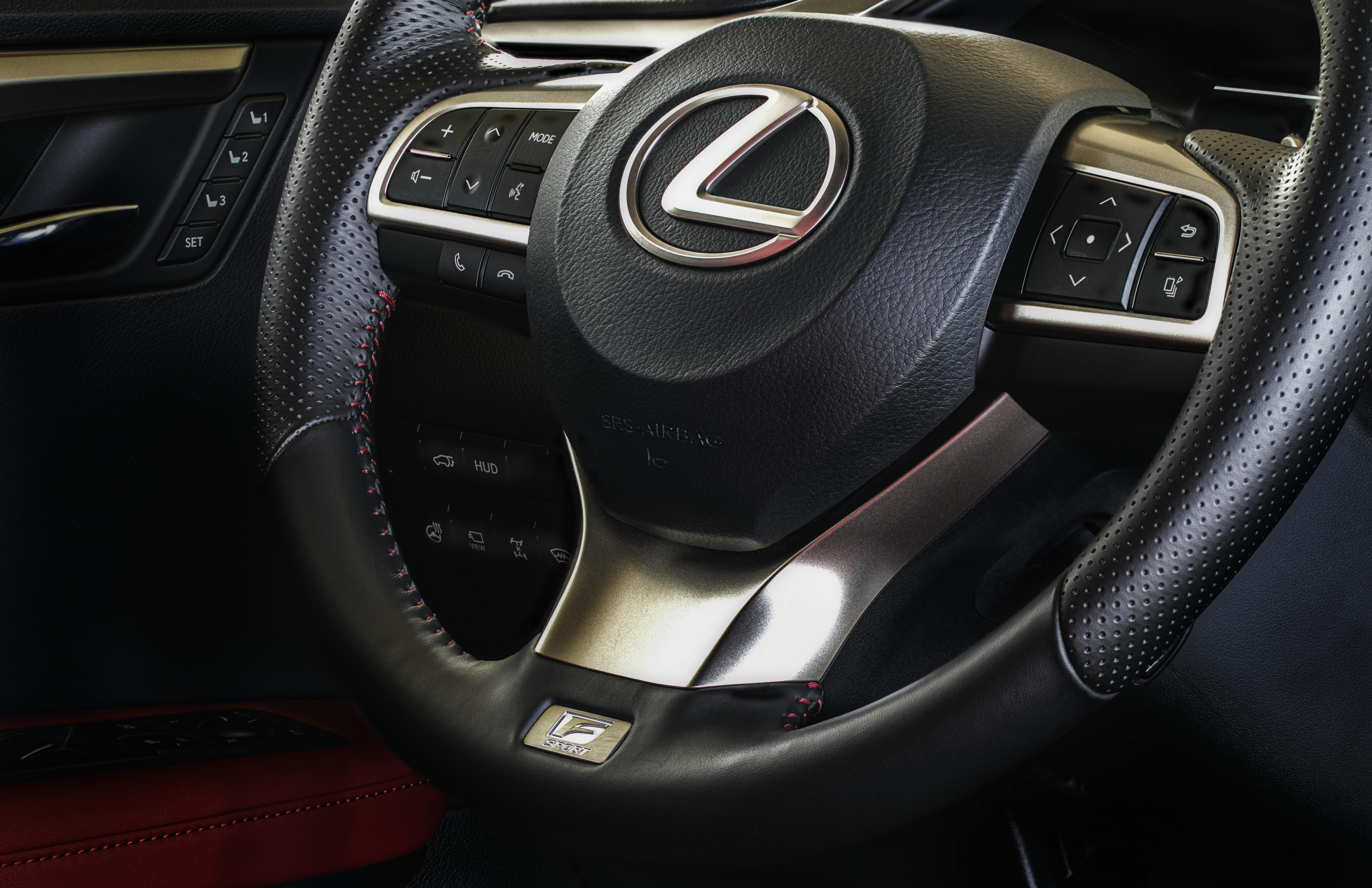 a black and gray lexus steering wheel with emblem