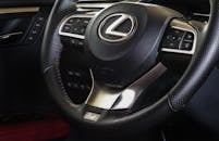 A Black and Gray Lexus Steering Wheel with Emblem