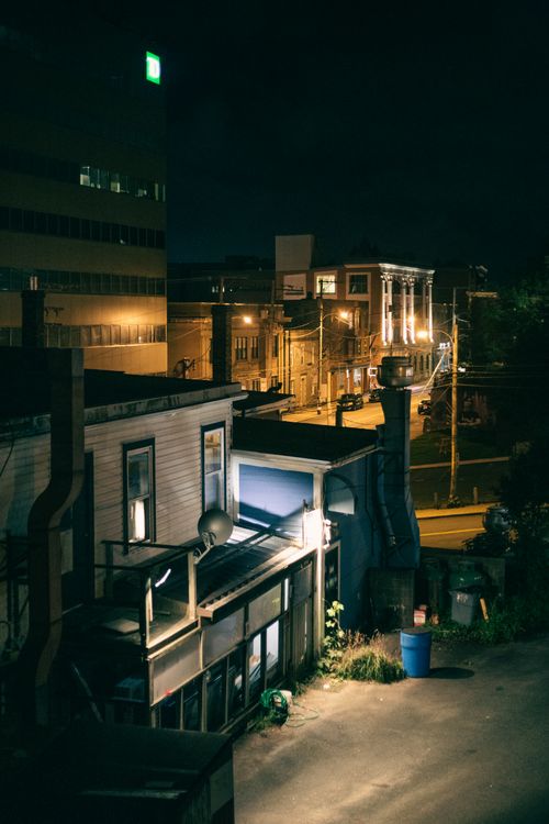 Free Moody urban street view at night with illuminated buildings and a gritty atmosphere. Stock Photo