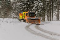 在德国埃塔尔，一辆扫雪机正在清理穿过森林的积雪道路