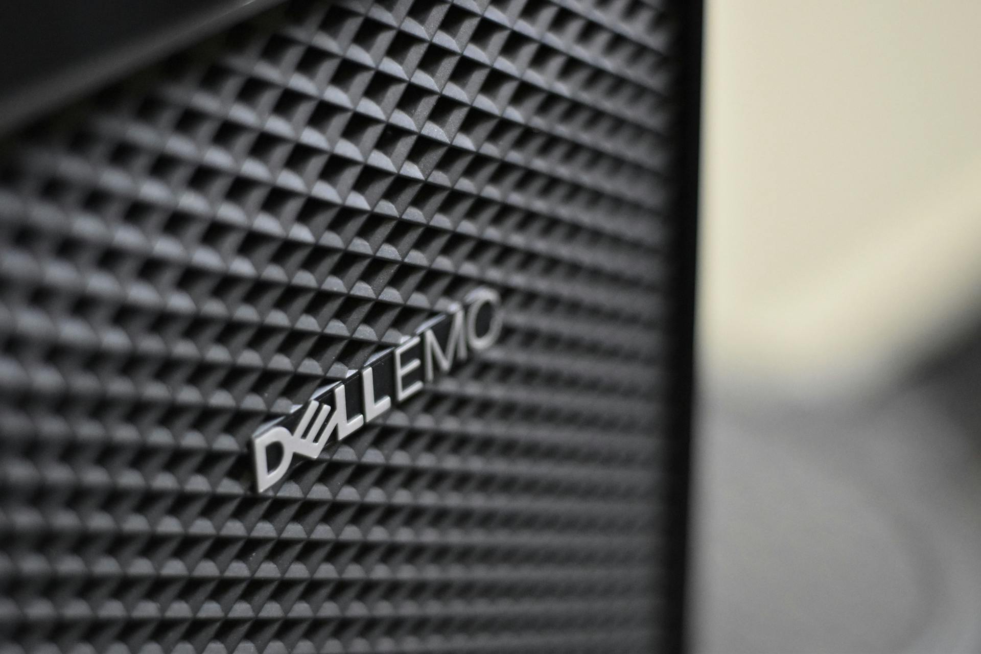 Detailed close-up of Dell EMC server logo on hardware grill with shallow focus and textured patterns.