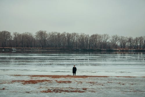 Person Standing Near Body of Water
