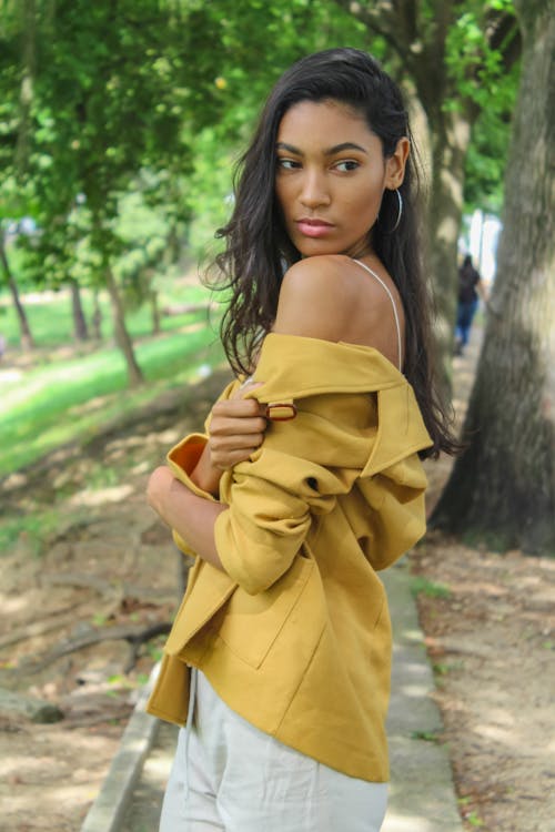 Woman Removing Her Yellow Blazer