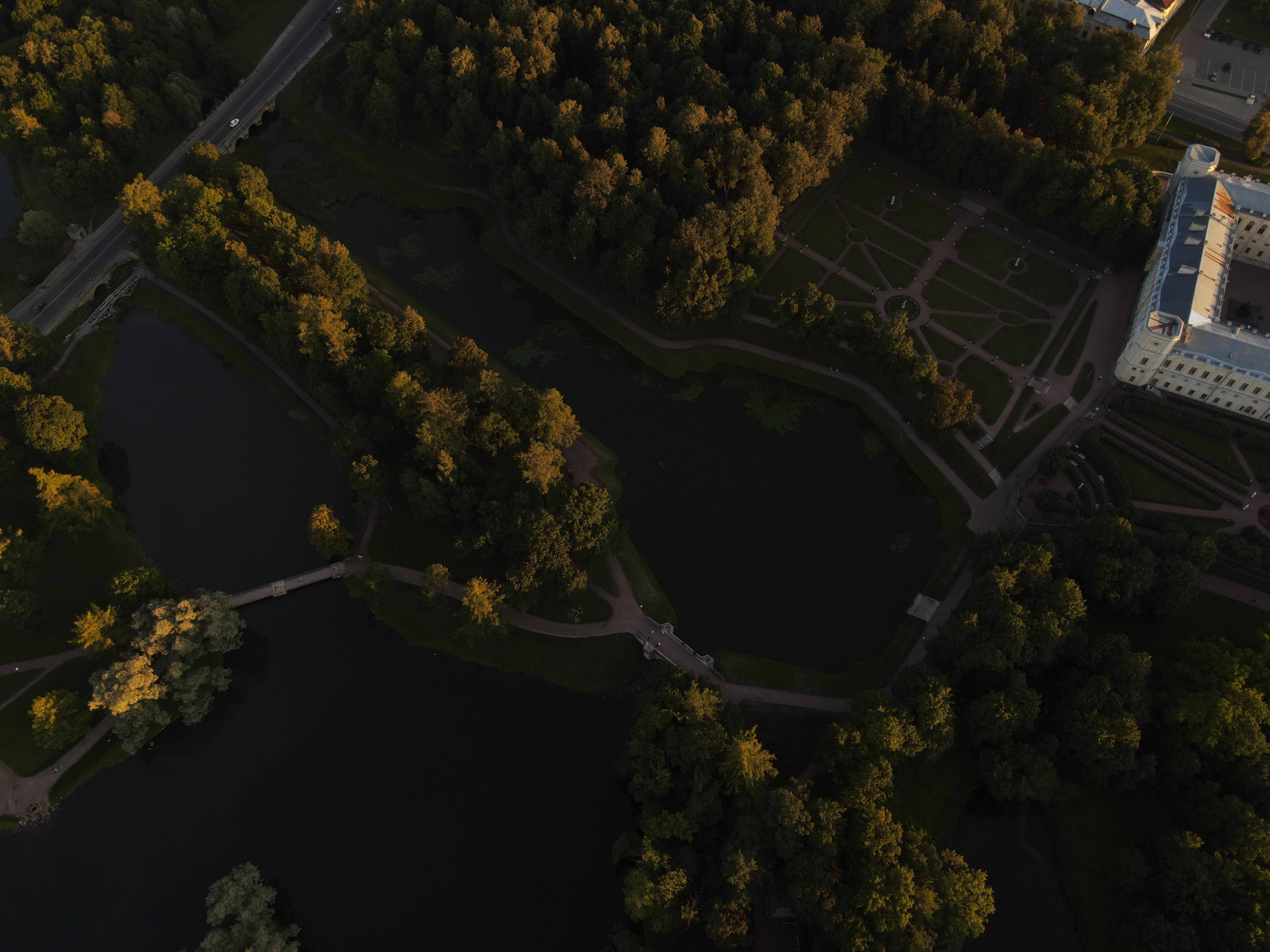 Drone shot capturing the serene parkland and Gatchina Palace at sunset.